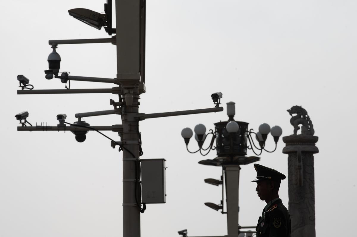 A Chinese paramilitary policeman stands guard before security cameras at Tiananmen Square in Beijing on April 8, 2019. Three decades after the crackdown on Tiananmen protesters, the tanks that lined Beijing's central avenue have been replaced by countless surveillance cameras perched like hawks on lampposts to keep the population in check. (STR/AFP via Getty Images)