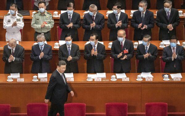 Chinese president Xi Jinping is applauded by delegates wearing protective masks as he arrives at the opening of the National People's Congress at the Great Hall of the People in Beijing, China on May 22, 2020. (Kevin Frayer/Getty Images)
