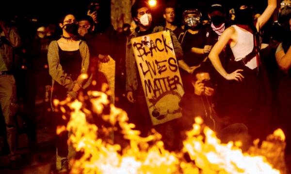 A Black Lives Matter protester seen at a riot in Portland, Ore., on Aug. 1, 2020. (Noah Berger/AP Photo)