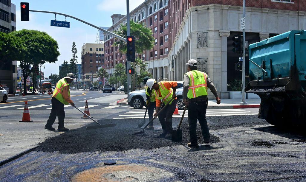 Workers resurface a road by pouring a new layer of asphalt in Los Angeles, on June 24, 2019. (Frederic J. Brown/AFP via Getty Images)