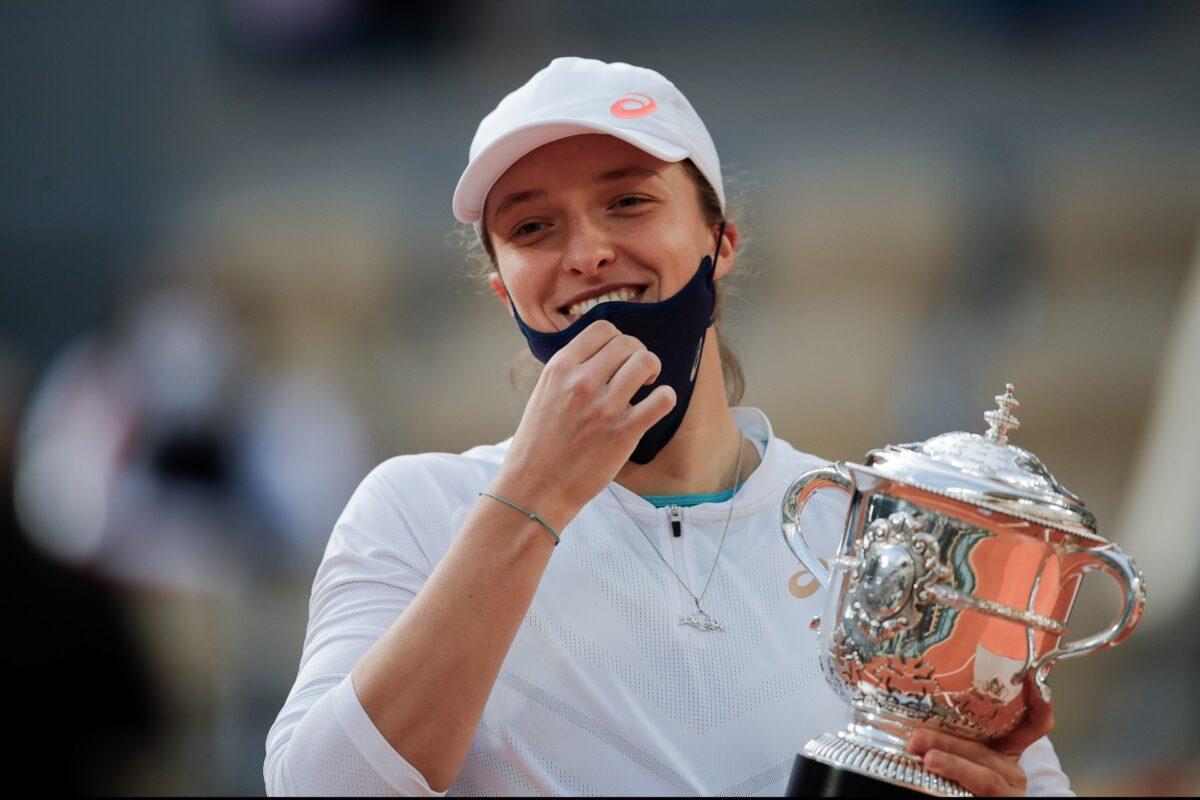 Poland's Iga Swiatek holds the trophy after winning the final match of the French Open tennis tournament against Sofia Kenin of the United States in two sets 6-4, 6-1, at the Roland Garros stadium in Paris, France, Oct. 10, 2020. (Christophe Ena/AP Photo, File)