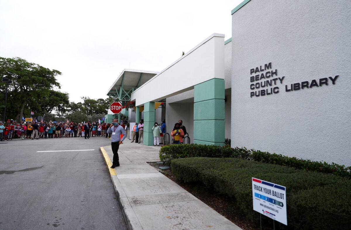 People gather outside Palm Beach County Library voting site where President Donald Trump casts his ballot ahead of the presidential election, in West Palm Beach, Fla., on Oct. 24, 2020. (Tom Brenner/Reuters)