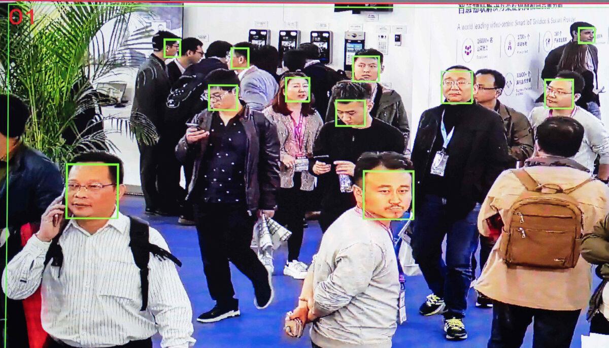 A screen shows visitors being filmed by AI (artificial intelligence) security cameras with facial recognition technology at the 14th China International Exhibition on Public Safety and Security at the China International Exhibition Center in Beijing, on Oct. 24, 2018. (Photo by Nicolas Asfouri/AFP via Getty Images).