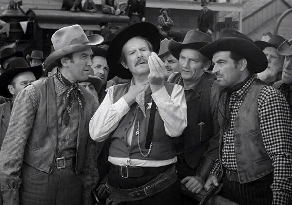 Wyatt Earp, C (Will Geer) explains the merits of the repeating Winchester rifle to (L–R) Lin McAdam (James Stewart), High Spade (Millard Mitchell), and Dutch Henry Brown (Stephen McNally) , in “Winchester ’73.” (Universal Pictures)