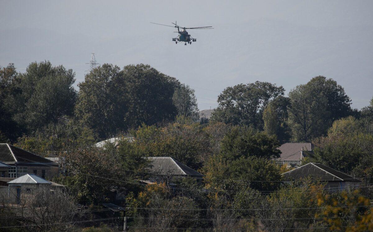An Azerbaijani military helicopter flies during the fighting over the breakaway region of Nagorno-Karabakh near the city of Terter, Azerbaijan, on Oct. 23, 2020. (Umit Bektas/Reuters)