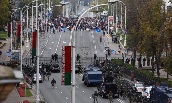 Belarusian law enforcement officers and service members block a street during an opposition rally to reject the presidential election results in Minsk, on Oct. 25, 2020. (Stringer/Reuters)