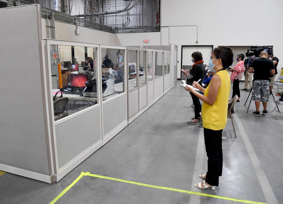 Observers and members of the media look on as Clark County election workers scan mail-in ballots at the Clark County Election Department in North Las Vegas, Nev., on Oct. 20, 2020. (Ethan Miller/Getty Images)