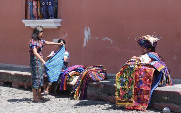 Guatemalan women sell brightly colored traditional tapestries to visitors on the streets of Antigua, Guatemala. (Courtesy of Barbara Selwitz)