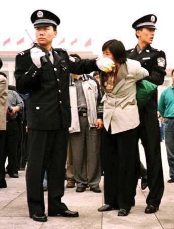 A Falun Gong practitioner is silenced in Tiananmen Square, Beijing, sometime after July 20, 1999. (Minghui.org)