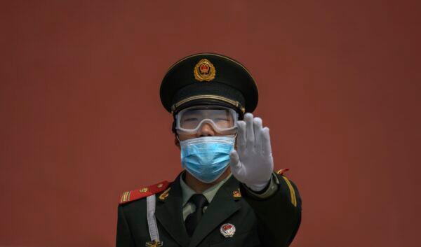 A paramilitary police officer stands guard in Beijing on May 1, 2020.