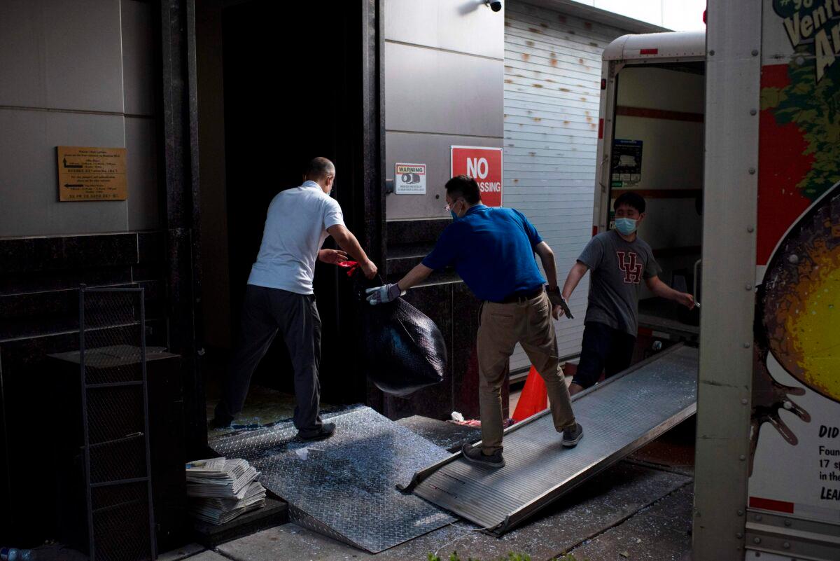 People move trash bags from the Chinese consulate in Houston, Texas, on July 24, 2020, after the U.S. State Department ordered China to close the consulate. (Mark Felix/AFP via Getty Images)