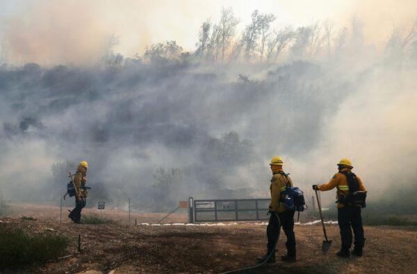 Firefighters work to contain the Silverado Fire in Irvine, Calif., on Oct. 26, 2020. (Mario Tama/Getty Images)