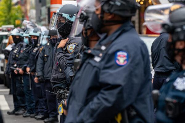 Officers create a physical barrier to keep Trump supporters and counter-protesters separated at a march and rally for President Donald Trump at Times Square in New York on Oct. 25, 2020. (David Dee Delgado/Getty Images)