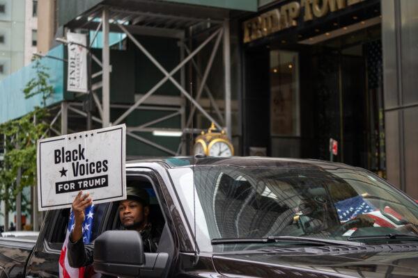 A person holds a sign for Black Voices for Trump at a march and rally for President Donald Trump on 5th Avenue in New York on Oct. 25, 2020. (David Dee Delgado/Getty Images)