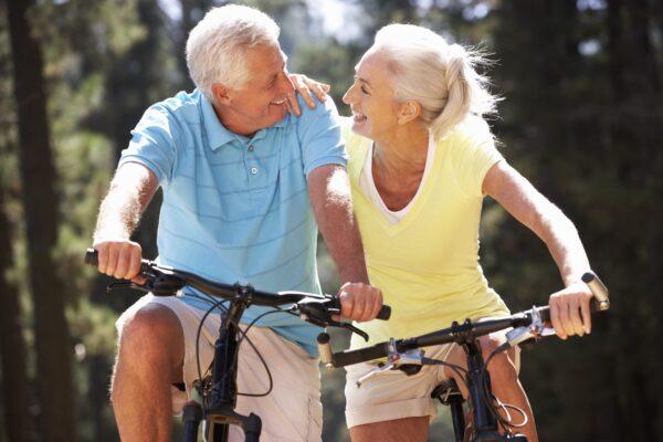 A couple enjoys sunlight while riding bikes. (Monkey Business Images/Shutterstock)