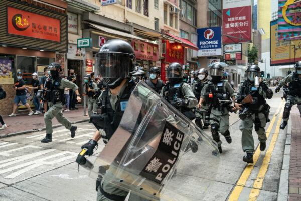 Riot police chase demonstrators in Hong Kong, on July 1, 2020. (Anthony Kwan/Getty Images)