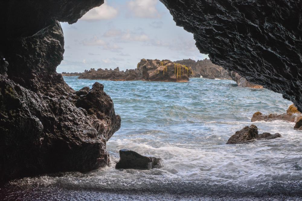 Looking out at the ocean from a sea cave at Waianapanapa State Park. (Realest Nature/Shutterstock)