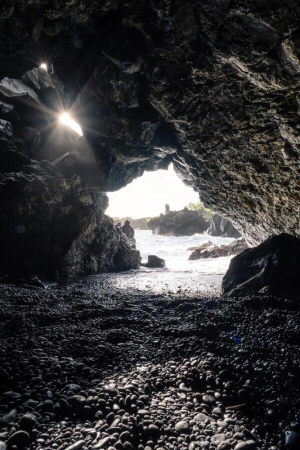A lava tube leads to the ocean on Black Sand Beach in Waianapanapa State Park. (Raphael Rivest/Shutterstock)