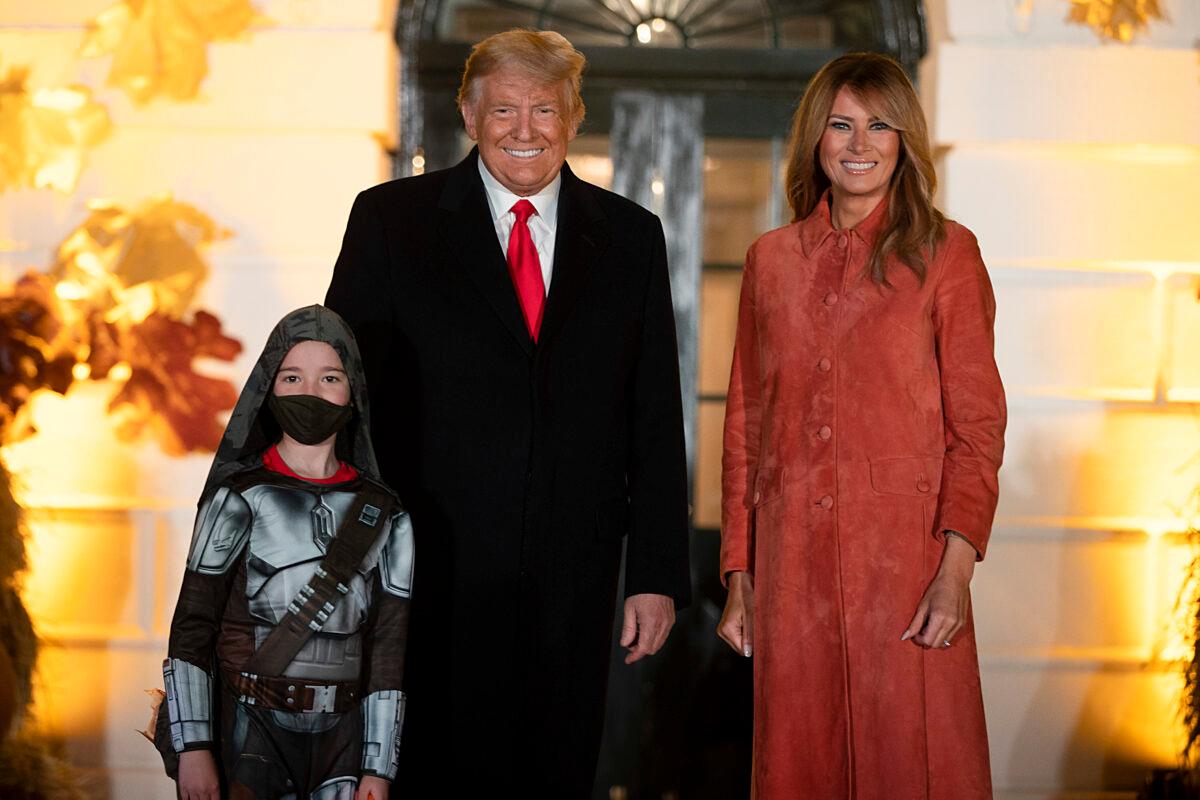 President Donald Trump and First Lady Melania Trump greet guests on the south lawn of the White House in Washington on Oct. 25, 2020. (Tasos Katopodis/Getty Images)