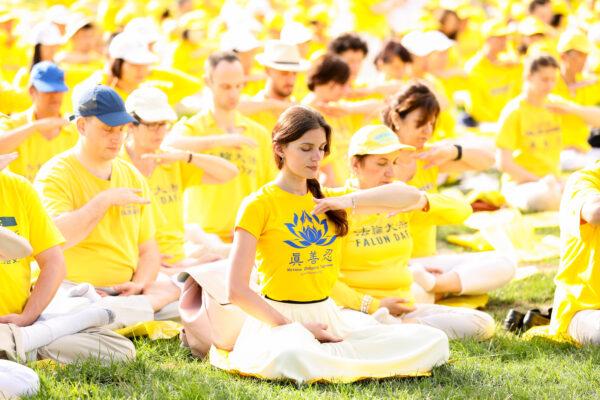 Falun Gong practitioners meditate prior to a rally that called for an end to the persecution of Falun Gong in China, on Capitol Hill in Washington, on June 20, 2018. (Samira Bouaou/The Epoch Times)