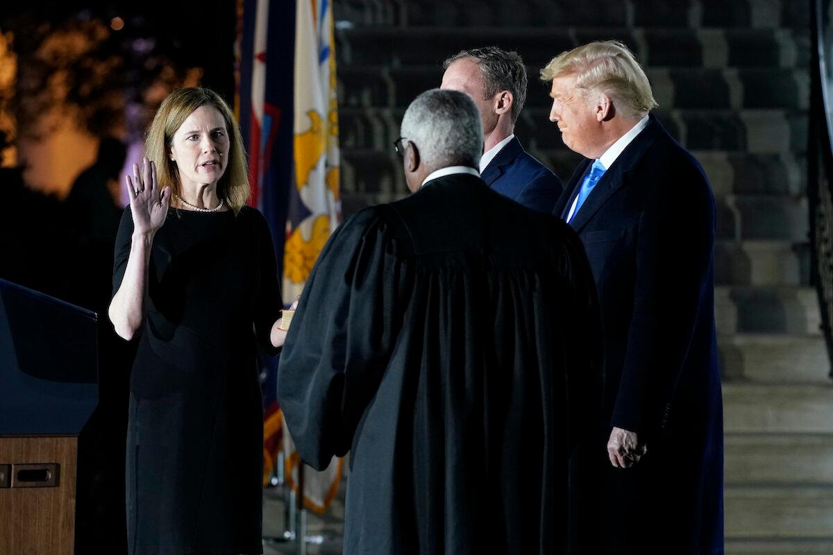  President Donald Trump watches as Supreme Court Justice Clarence Thomas administers the Constitutional Oath to Amy Coney Barrett on the South Lawn of the White House in Washington on Oct. 26, 2020. (Patrick Semansky/AP Photo)
