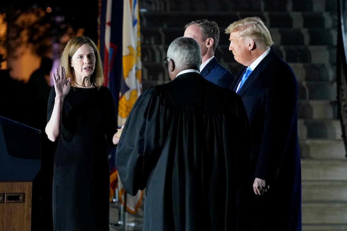 President Donald Trump watches as Supreme Court Justice Clarence Thomas administers the Constitutional Oath to Amy Coney Barrett on the South Lawn of the White House in Washington on Oct. 26, 2020. (Patrick Semansky/AP Photo)