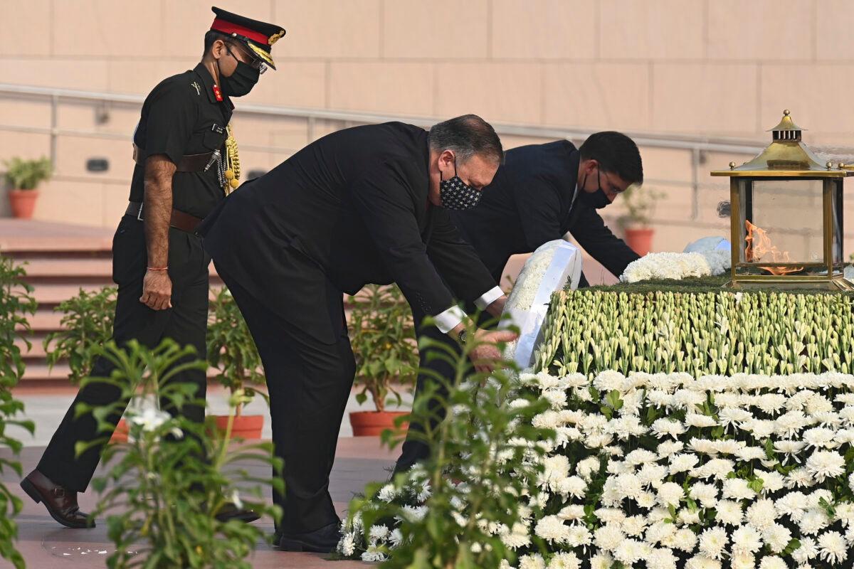 U.S. Secretary of State Mike Pompeo, left, and Secretary of Defence Mark Esper pay their tributes at the National War Memorial in New Delhi, India, Tuesday, Oct. 27, 2020. (Jewel Samad/Pool via AP)