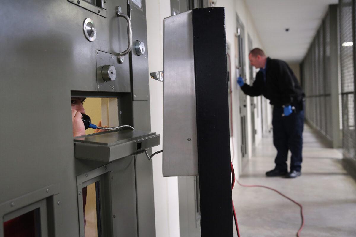 A detainee makes a call from his “segregation cell” at the Adelanto Detention Facility, in Adelanto, Calif., on Nov. 15, 2013. (John Moore/Getty Images)