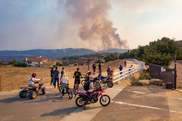 Spectators watch smoke rising in the distance from the Blue Ridge Fire in Chino Hills, Calif., on Oct. 27, 2020. (John Fredricks/The Epoch Times)