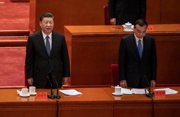 Chinese leader Xi Jinping (left) and Premier Li Keqiang sing the national anthem at a ceremony marking the 70th anniversary of China's entry into the Korean War at the Great Hall of the People in Beijing, China on Oct. 23, 2020. (Kevin Frayer/Getty Images)