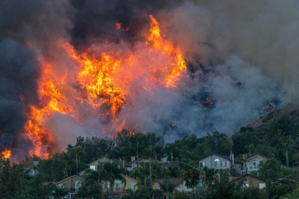 Flames rise near homes during the Blue Ridge Fire in Chino Hills, Calif., on Oct. 27, 2020. (David McNew/Getty Images)