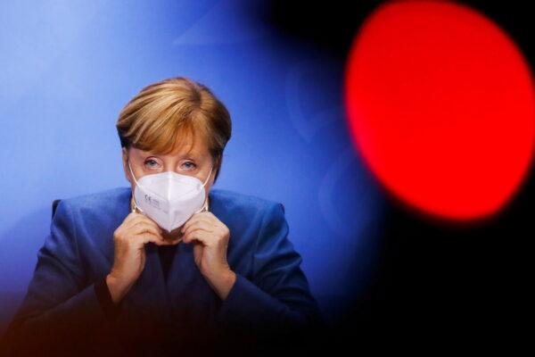 German Chancellor Angela Merkel puts on her face mask at the end of a news conference at the Chancellery in Berlin, Germany, Oct. 28, 2020.(Fabrizio Bensch/Pool/Reuters)