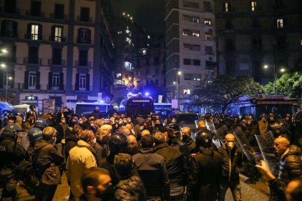 Demonstrators protesting against government restrictions amid the COVID-19 pandemic face Italian anti-riot policemen in front of Campania region President Vincenzo De Luca's headquarters in the city centre of Naples, on Oct. 23, 2020. (Carlo Hermann/AFP via Getty Images)