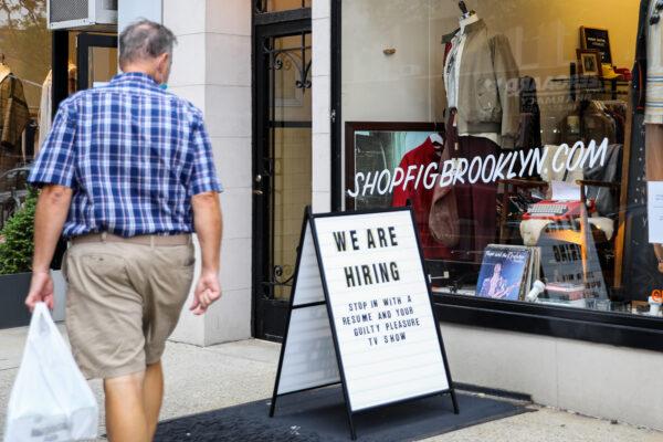 A hiring sign is displayed in front of a store in Brooklyn, New York, on Oct. 7, 2020. (Chung I Ho/The Epoch Times)