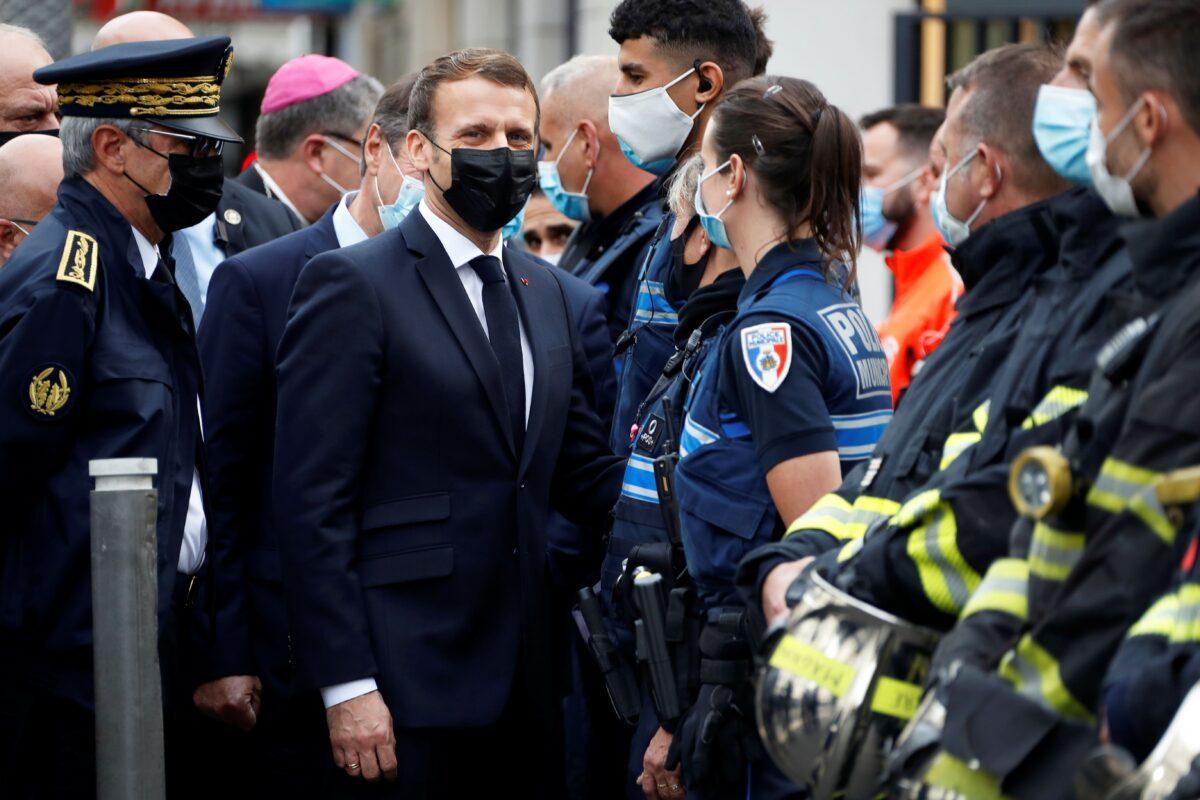 French President Emmanuel Macron (2nd-L) visits the scene of a knife attack at the Basilica of Notre-Dame de Nice in Nice, on Oct. 29, 2020. (Eric Gaillard/pool/AFP via Getty Images)