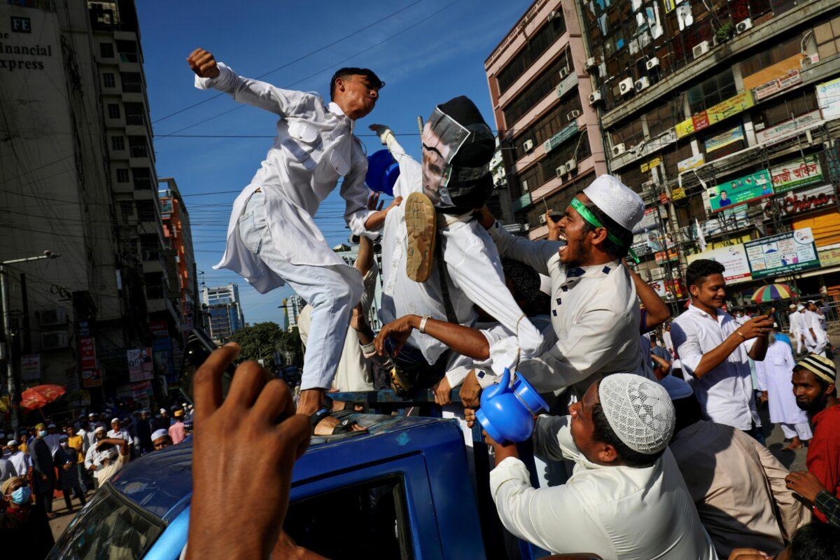 Muslims hit the effigy depicting the French president Emmanuel Macron after Friday prayer as they take part in a protest calling for the boycott of French products and denouncing Macron for his comments over Prophet Muhammed’s caricatures, in Dhaka, Bangladesh, on Oct. 30, 2020. (Mohammad Ponir Hossain/Reuters)