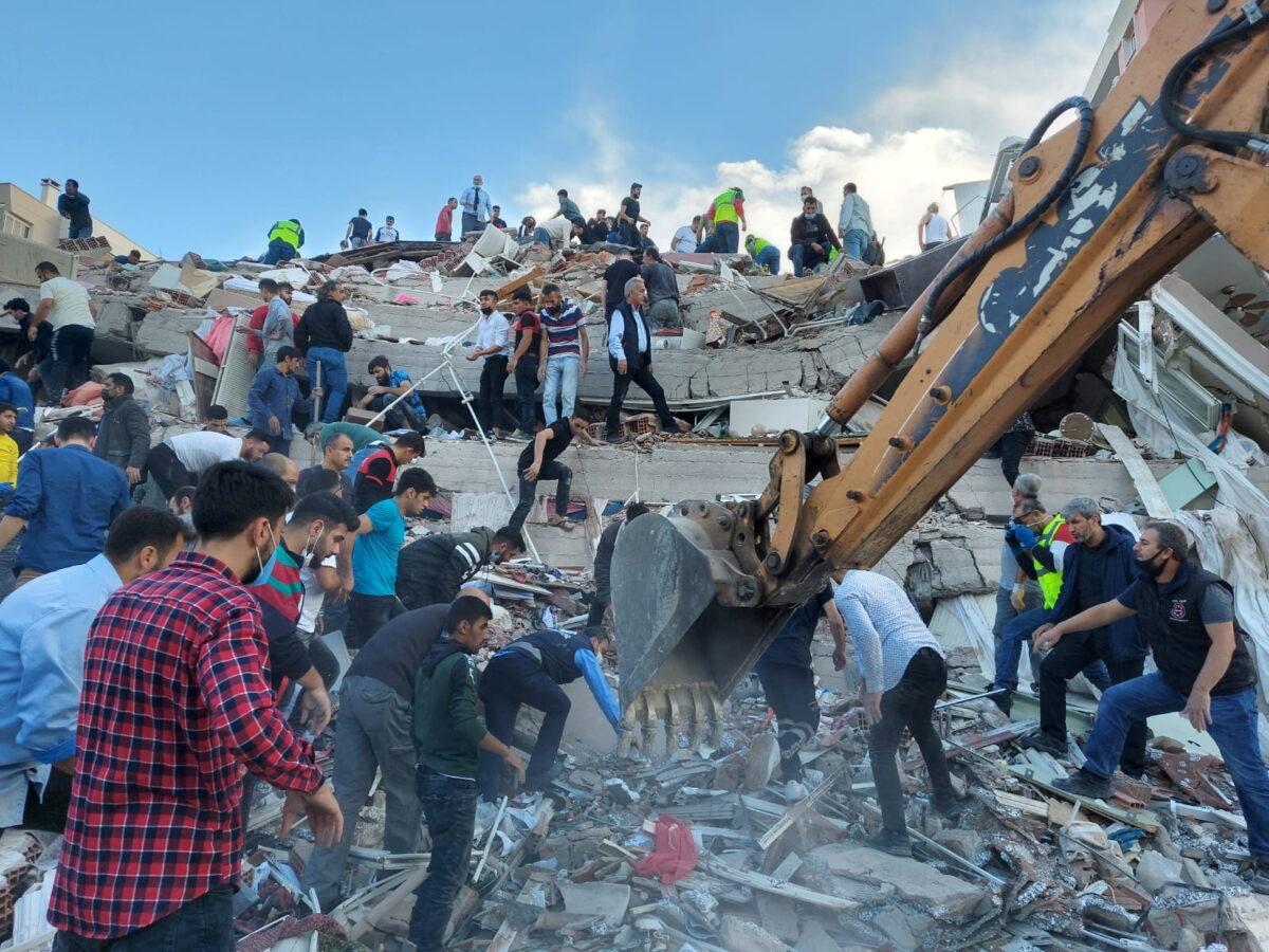 Locals and officials search for survivors at a collapsed building after a strong earthquake struck the Aegean Sea and was felt in both Greece and Turkey, where some buildings collapsed in the coastal province of Izmir, Turkey, on Oct. 30, 2020. (Tuncay Dersinlioglu/Reuters)