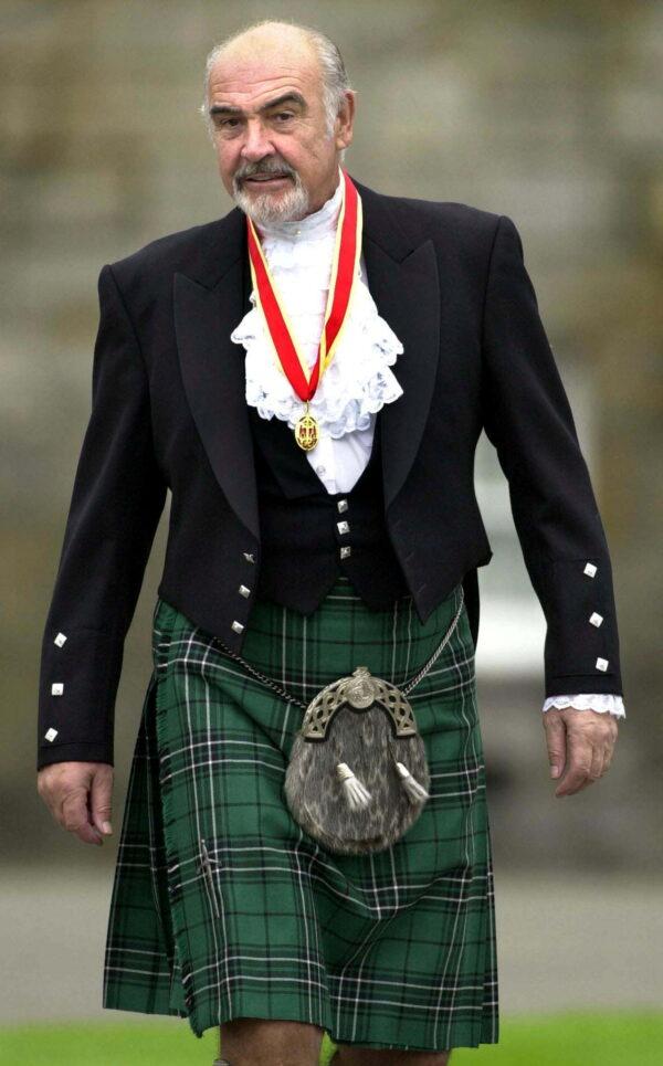  Sir Sean Connery wearing full highland dress walks towards waiting journalists after he was formally knighted by Britain's Queen Elizabeth at Holyrood Palace in Edinburgh on July 5, 2000. (File Photo via Reuters)