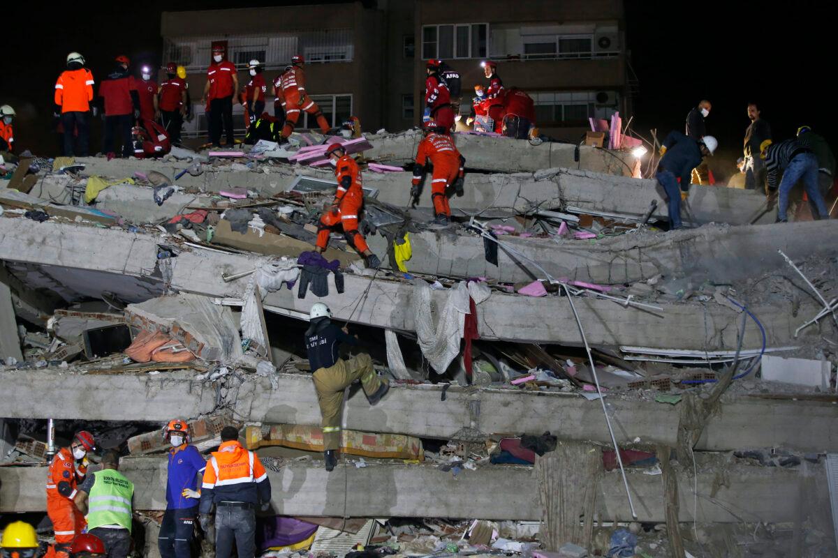 Members of rescue services search in the debris of a collapsed building for survivors in Izmir, Turkey, on Oct. 31, 2020. (Emrah Gurel/AP Photo)