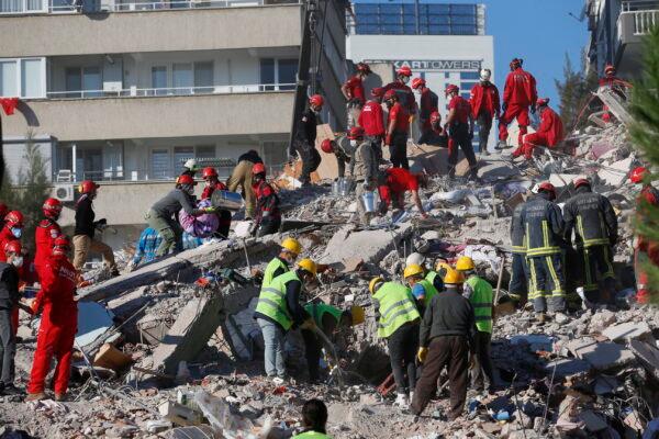 Members of rescue services search for survivors in the debris of a collapsed building in Izmir, Turkey, Oct. 31, 2020. (Darko Bandic/AP Photo)
