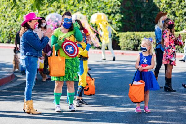 Parents, children, and staff wear costumes as part of the annual trick-or-treat parade event in front of Fountain Valley Regional Hospital in Fountain Valley, Calif., on Oct. 30, 2020. (John Fredricks/The Epoch Times)