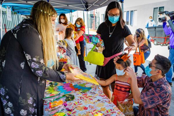 Children enjoy an arts and crafts exhibit as part of the annual trick-or-treat parade at Fountain Valley Regional Hospital in Fountain Valley, Calif., on Oct. 30, 2020. (John Fredricks/The Epoch Times)
