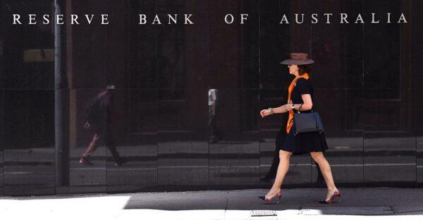 A woman walked past the Reserve Bank of Australia sign in Sydney on October 4, 2016. (WILLIAM WEST/AFP via Getty Images)