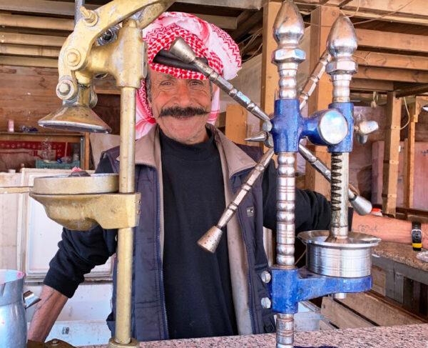 A Bedouin who once lived and worked in Petra, Jordan, now serves coffee to visitors from his shop. (Courtesy of Phil Allen)