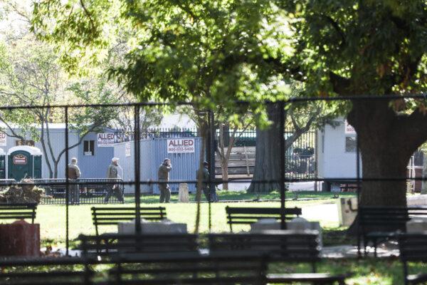 Law enforcement personnel and portable sheds are seen inside the fortified White House perimeter in Lafayette Square in preparation for Election Day, in Washington, on Nov. 2, 2020. (Charlotte Cuthbertson/The Epoch Times)