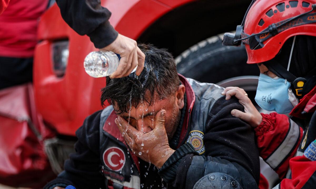 A member of rescue services takes a break during the search for survivors in the debris of a collapsed building in Izmir, Turkey, on Nov. 2, 2020. (Emrah Gurel/AP Photo)