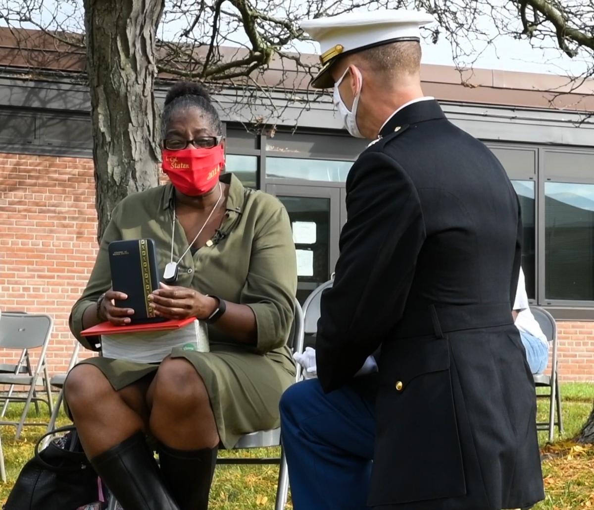 A U.S. Marine Corps Major with 4th Combat Engineer Battalion presents Lance Cpl. Corey Staten’s mother, Nancy Staten, the Navy and Marine Corps Medal during an award ceremony in Baltimore, Oct. 24, 2020. (<a href="https://www.dvidshub.net/image/6406896/lance-cpl-corey-statens-award-ceremony">Lance Cpl. Dylon Grasso</a>/U.S. Marine Corps)