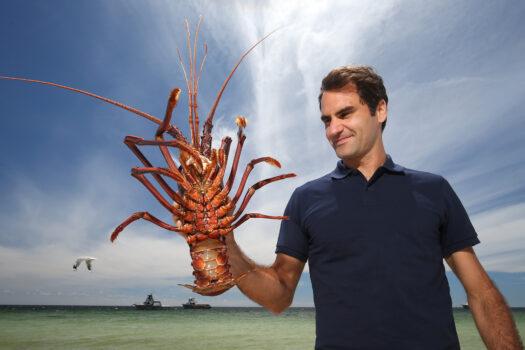Tennis player Roger Federer holds a Western Rock Lobster on the beach ahead of the 2019 Hopman Cup in Cervantes, Australia, on Dec. 27, 2018. (Paul Kane/Getty Images)