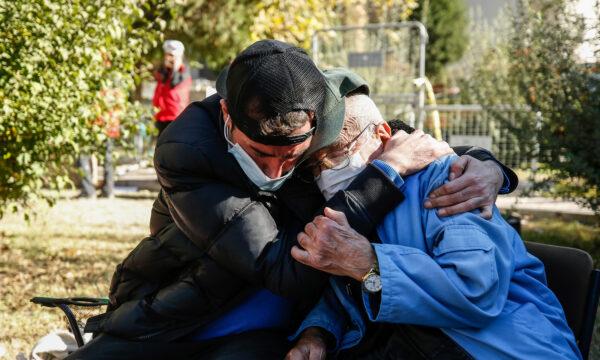 Local residents comfort each other as they watch members of rescue services working on the search for survivors in the debris of a collapsed building, in Izmir, Turkey, on Nov. 2, 2020.(Emrah Gurel/AP Photo)