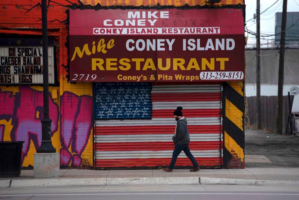A man passes a closed restaurant in Detroit on March 24, 2020. (Seth Herald/AFP via Getty Images)